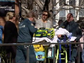 In this image made from video, injured students are attended to at Australian National University in Canberra, Australia, Friday, Aug. 25, 2017. (Australian Broadcasting Corporation via AP)