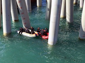 A handout picture released by Russia's Emergency Ministry on Aug. 25, 2017 shows rescuers working near a pier after a bus carrying construction workers veered off a pier and plunged into the Black Sea, Krasnodar region. (RUSSIAN EMERGENCY MINISTRY/HO/AFP/Getty Images)