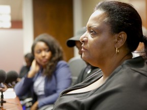 A 25-year-old North York man, who alleges he was assaulted by Toronto Police officers after being mistaken for a suspect in a shooting, shared his ordeal during a news conference at the African Canadian Legal Clinic on Thursday, Aug. 24, 2017. ACLC Executive Director Margaret Parsons (right) and ACLC lawyer Lavinia Latham (left) flank their client, who asked not to be identified, during the press conference. (Chris Doucette/Toronto Sun)
