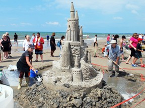 Sandy Stirling (left) of Dundas, and Dale Andrews of Burlington work on a giant sandcastle during the annual Sauble Sandfest in Sauble Beach held Aug. 17. Travel writer Bob Boughner says Sauble Beach, as well as numerous other vacation sites in Bruce County, make that region a magnet for visitor. And Boughner adds that it’s not too late to visit that part of Ontario. (Denis Langlois/Postmedia Network)