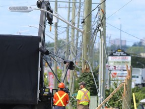 John Counter Boulevard was closed near Division Street Friday morning after a truck severed a hydro pole when it got entangled in wires. The road was closed in both directions while crews cleaned up the debris and replaced the pole. The incident caused a power outage in the John Counter Boulevard and Division Street area in Kingston, Ont. on Friday, Aug. 25, 2017. 
Elliot Ferguson/The Whig-Standard/Postmedia Network