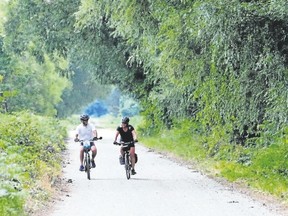Two riders travel through lush greenery on the Great Lakes Waterfront Trail. (Special to Postmedia News)