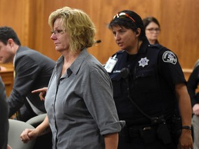 Monica Burke is led out of the courtroom and taken into custody by officers after her sentencing in Boulder, Colo., on Friday, Aug. 25, 2017. (Cliff Grassmick/Daily Camera via AP, Pool)