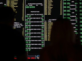 A board displays odds for different bets for the fight between Floyd Mayweather Jr. and Conor McGregor at the Westgate Superbook sports book on Aug. 24, 2017. (AP Photo/John Locher)