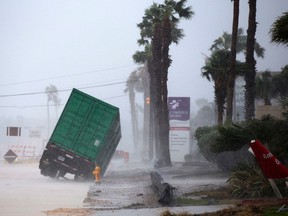 A power generator tips in in front of Texas' CHRISTUS Spohn Hospital Corpus Christi-Shoreline as Hurricane Harvey hits Friday, Aug. 25, 2017. (Courtney Sacco /Corpus Christi Caller-Times via AP)