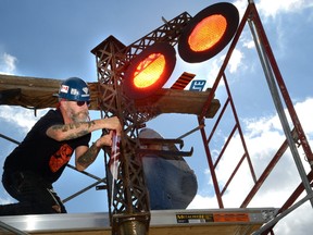 Blacksmith artist Scott McKay puts the finishing touches on one of two pieces of art he?s made to mark the creation of Canada?s first elevated park, atop the historic Michigan Central Railway Bridge in St. Thomas. A Sunday lunch fundraiser at the bridge will help to soft launch the project. (MORRIS LAMONT/The London Free Press)