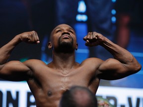 Floyd Mayweather Jr. poses on the scale during a weigh-in Friday, Aug. 25, 2017, in Las Vegas. Mayweather is scheduled to fight Conor McGregor in a boxing bout Saturday. (AP Photo/John Locher)