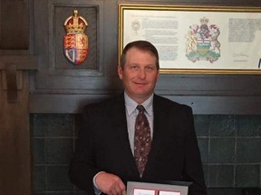 Whitecourt local Jeffrey Ingersoll stands with his St. John's Ambulance award, given to him in recognition of his efforts to save the life of a co-worker (Submitted photo).