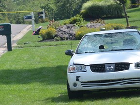 A vehicle with a destroyed windshield appears on a lawn in Mountain Top, Pa., after the driver plowed into seven people in a residential area. (Ellen F. O’Connell/Hazleton Standard-Speaker via AP)