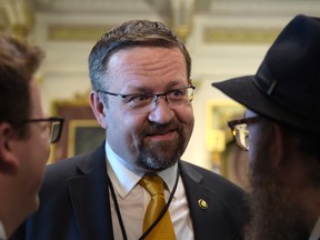 In this Tuesday, May 2, 2017 file photo, deputy assistant to President Trump, Sebastian Gorka, talks with people in the Treaty Room in the Eisenhower Executive Office Building. (AP Photo/Susan Walsh, File)