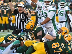 Saskatchewan Roughriders recovering a fumble by Edmonton Eskimos quarterback Mike Reilly during CFL action at Commonwealth Stadium on Friday. (Ed Kaiser)