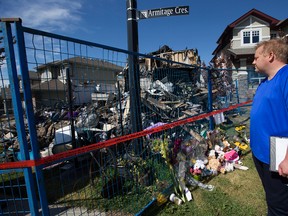 Cordell Brown looks at what is left of his home at 1040 Armitage Cres. SW in Edmonton, Friday Aug. 25, 2017. Brown’s five-month-old son died in hospital after fire crews pulled the baby and his mom, Angie Tang, from the second floor of the burning home around 4 a.m. Tuesday. Photo by David Bloom