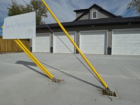 This four car garage attached to an infill fourplex, has guy wires mounted in the middle of the driveway on 105 Ave. near 150 St. in Edmonton, August 25, 2017. Ed Kaiser/Postmedia