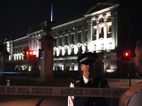 A police cordon outside Buckingham Palace where a man has been arrested after an incident, in London, Friday Aug. 25, 2017.(Lauren Hurley/PA via AP)