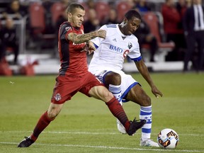 Toronto FC forward Sebastian Giovinco (10) and Montreal Impact midfielder Patrice Bernier (8) vie for control of the ball during second half Canadian Championship soccer action in Toronto on June 27, 2017. (THE CANADIAN PRESS/Nathan Denette)