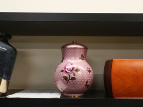 Urns on shelves at JJ Cardinal Funeral Home in Montreal, October 23, 2013. A brush and scoop are used to make sure no remains are lost.
