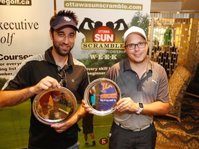 Adam Brennan, left, and Jeremy Kirk pose with their D Division runner-up plates at the Ottawa Scramble at the Marshes golf course in Ottawa on Saturday, August 26, 2017. (Patrick Doyle)