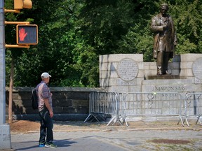A man looks at a statue in New York's Central Park statue honouring Dr. J. Marion Sims, known as the “father of modern gynecology," on Aug. 22, 2017. (Bebeto Matthews/AP Photo)
