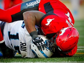 Toronto Argonauts quarterback Ricky Ray is sacked by Micah Johnson of the Stampeders last night in Calgary. (Al Charest/Postmedia)