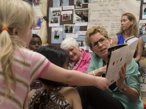 Ontario Premier Kathleen Wynne reads to a full-day kindergarten class in Guelph during the 2014 election campaign. (THE CANADIAN PRESS)