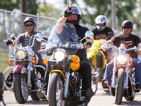 A biker waves as hundreds of motorcycles leave Centennial Park for the annual Quinte Ride For Paws on Sunday August 27, 2017 in Trenton, Ont. Tim Miller/Belleville Intelligencer/Postmedia Network