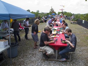 People enjoy a lunch during on the Elevated Park during a fundraising picnic atop the 27-meter high defunct railway bridge in St. Thomas, Ont. on Sunday, August 27, 2017. (DEREK RUTTAN, The London Free Press)