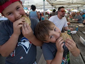 Jaxon Kellar (10) (left) and Draedan Horvath (6) chow down on tacos at the London Taco Fest on Saturday, August 26, 2017. Hundreds attended the event at Covent Garden Market that featured vendors serving up authentic tacos, quesadillas, churros and Mexican cocktails. The London boys loved the tacos, scoring them 10 out of 10. They attended the event with Draedan's mom Jenna Toonders. (DEREK RUTTAN, The London Free Press)