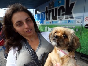 Ani Tourosian and her dog, Mia, outside the city's  Spay or Neuter Your Pet mobile clinic. (DAVE ABEL, Toronto Sun)