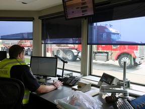 A peace officer monitors vehicles at the Commercial Vehicle Inspection Station south of Edmonton on August 24, 2017, where software designed by Drivewyze is in use.