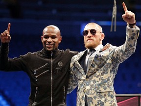 Floyd Mayweather Jr., left, and Conor McGregor pose during a news conference Sunday, Aug. 27, 2017, in Las Vegas. (AP Photo/Isaac Brekken)