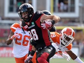 Ottawa Redblacks’ Brad Sinopoloi (88) tries to make his way past B.C. Lions’ Tony Burnett (26) and Chandler Fenner (39) in Ottawa on Saturday, Aug. 26, 2017. (THE CANADIAN PRESS/Justin Tang)