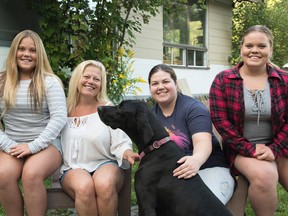 Nicole Marshall with her three daughters: Joelle, 11 (left); Aimee, 25; and Alaissia, 13. Lily the Great Dane refused to look at the camera. They have spent 14 years camping at Dutrisac Cottages. Mary Katherine Keown/The Sudbury Star