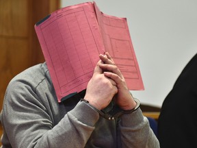 In this Feb. 26, 2015 file photo former nurse Niels Hoegel., accused of multiple murder and attempted murder of patients, covering his face with a file at the district court in Oldenburg, Germany. German authorities say Monday Aug. 28, 2017 they now believe that a nurse who was convicted of killing patients with overdoses of heart medication killed at least 84 people. Niels Hoegel was convicted in 2015 of two murders and two attempted murders at a clinic in the northwestern town of Delmenhorst. Oldenburg police chief Johann Kuehme said Monday authorities have now unearthed evidence of 84 killings. (Carmen Jaspersen/dpa via AP,file)