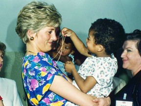 In this April 24, 1991 file photo, Britain's Princess Diana, the Princess of Wales, hugs and plays with an HIV positive baby in Faban Hostel, San Paulo, on the second day of her visit to Brazil. It has been 20 years since the death of Princess Diana in a car crash in Paris and the outpouring of grief that followed the death of the “people’s princess.”
(AP Photo/Dave Caulkin, File)