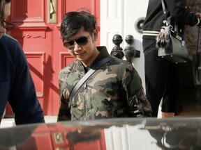 In this April 5, 2017, photo, Vorayuth "Boss" Yoovidhya, whose grandfather co-founded energy drink company Red Bull, walks to get in a car as he leaves a house in London. (AP Photo/Matt Dunham)