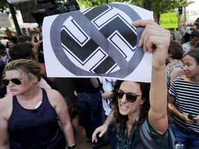 Protesters shout anti-Nazi chants after chasing alt-right blogger Jason Kessler from a news conference August 13, 2017 in Charlottesville, Virginia. (Photo by Chip Somodevilla/Getty Images)
