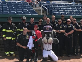 Sawyer Fish is seen with Portland police officers and firefighters at Hadlock Field in Portand, Maine on August 27, 2017. (Twitter/Make-A-Wish Maine)