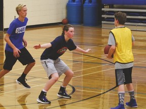 Luke Jackson, left, Jocelyn Stewart and Kaiden Fulton practise a pick-and-roll offence Aug. 21 at the Cultural-Recreational Centre.