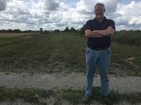 Dennis German, president of German Solar Corporation, stands just outside of St. Thomas on land that was formerly a CN rail corridor. The land will become one of 22 solar farms in the region. (Laura Broadley/Times-Journal)