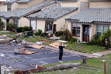 A woman photographs damage at the Bay House Condominiums in Rockport, Texas in the wake of Hurricane Harvey on Monday, Aug. 28, 2017. (Rachel Denny Clow/Corpus Christi Caller-Times via AP) ORG XMIT: TXCOR218