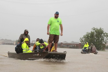 HOUSTON, TX - AUGUST 28:  People are rescued from a flooded neighborhood after it was inundated with rain water, remnants of Hurricane Harvey, on August 28, 2017 in Houston, Texas. Harvey, which made landfall north of Corpus Christi late Friday evening, is expected to dump upwards to 40 inches of rain in areas of Texas over the next couple of days.  (Photo by Scott Olson/Getty Images)