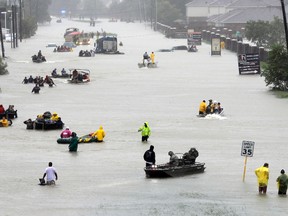 Rescue boats fill a flooded street as flood victims are evacuated as floodwaters from Tropical Storm Harvey rise Monday, Aug. 28, 2017, in Houston. (AP Photo/David J. Phillip) ORG XMIT: TXDP401