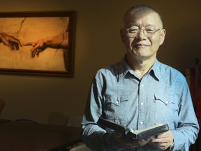 Pastor Hyeon Soo Lim holds the bible he kept with him while in North Korea, at the Light Korean Presbyterian Church on Monday, August 28, 2017. (Veronica Henri/Toronto Sun)