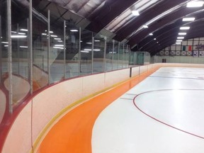 This Facebook photo posted by a paralysis foundation shows a hockey rink painted with an orange warning line around the boards in an effort to make players aware of the boards and keep their heads up to reduce injury. (Facebook/The Thomas E. Smith Foundation)