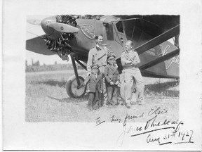 The Sir John Carling airplane with pilot, Terrence Tully and navigator, James V. Medcalf, posing with two unidentified boys before their flight, 1927. “London to London” is lettered on the plane behind them. (Ivey Family London Room, London Public Library)