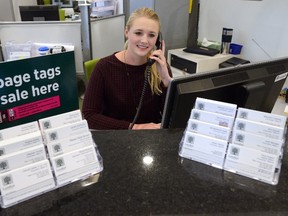 Alana Nelligan fields phone calls at the main floor lobby service desk at London City Hall. Despite all the digital methods of asking for service from the city, most requests still come in on the phone line. (MORRIS LAMONT, The London Free Press)