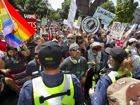 Counter-protesters scream at Pegida protesters behind a line of police outside of city hall in London, Ont. on Saturday August 26, 2017. More than 500 people counter-protested approximately 30 supporters of Pegida Canada (Patriots of Canada against the Islamization of the West). (Derek Ruttan/The London Free Press)