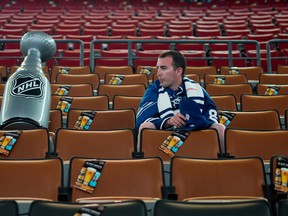 A fan sits in the empty seats near a blow-up Stanley Cup before the start of the Toronto Maple Leafs and the Boston Bruins fourth game of their first round playoff series at Air Canada Centre on May 8, 2013. (Tyler Anderson/National Post)