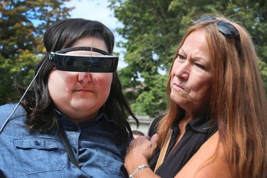 Cheyenne Field, a legally blind 17-year-old from Toronto can now see thanks to eSight on Tuesday August 29, 2017.The  new electronic glasses enable the legally blind to actually see. Fields wore them for the first time at Casa Loma in Toronto is overwhelmed with emotion in the arms of her grandmother Sandra Smith. Veronica Henri/Toronto Sun/Postmedia Network