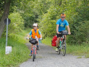 James Potvin, 9, and his father Chris Potvin, arrive in Sydenham on Tuesday, which is about halfway through their cycling adventure from Whitby to Giver Playground in Mooney's Bay, Ottawa. James, who has been diagnosed with autism, is helping raise awareness and fund for the Grandview Children’s Centre, to help support more Grandview Kids, just like him. (Julia McKay/The Whig-Standard)